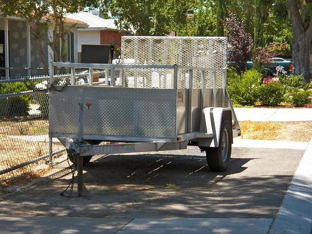 Light-duty utility trailer with an open top and rear gate.